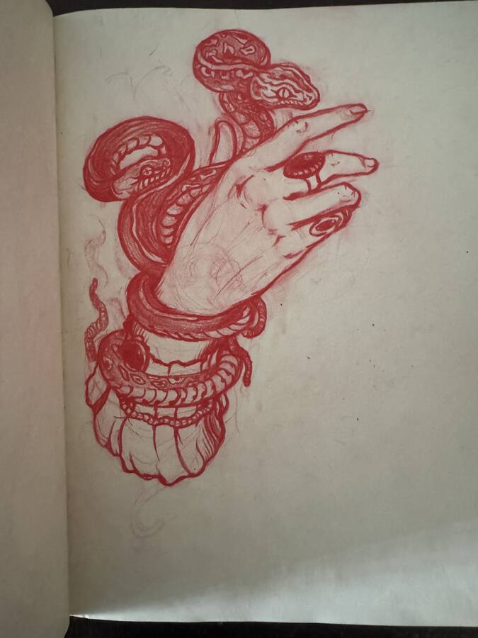 Page de carnet, croquis rouge d'une main et d'un serpent