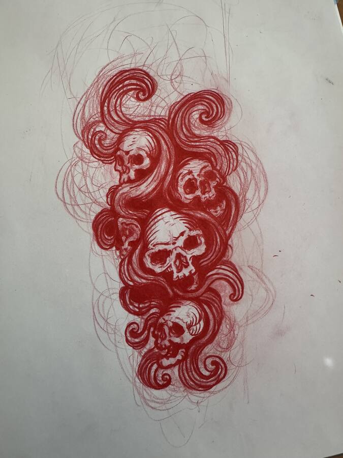 Page de carnet, croquis rouge de crânes dans les nuages