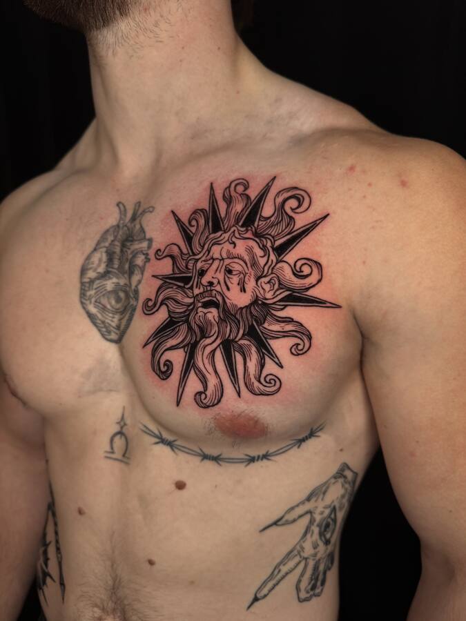 Soleil à visage tatoué sur la poitrine